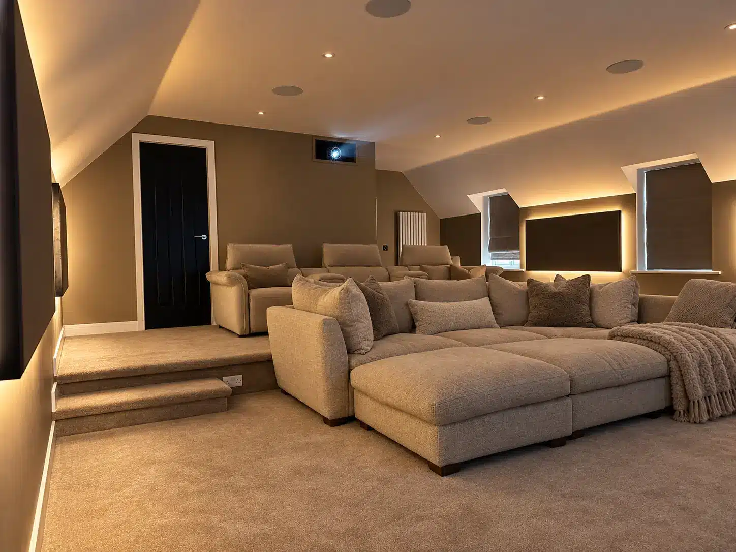 Yarm home cinema seen from the rear, with a large sofa facing the screen